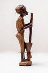 wooden carving woman pounding