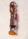 woman carrying water wooden carving