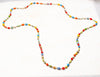 YELLOW, RED AND BROWN JACARANDA WOOD AND PLASTIC BEADS IN CHITENGE MATERIAL NECKLACE , PAIRED WITH EARRINGS AND AN AFRICAN MAIDEN PRINTED WRAPPER